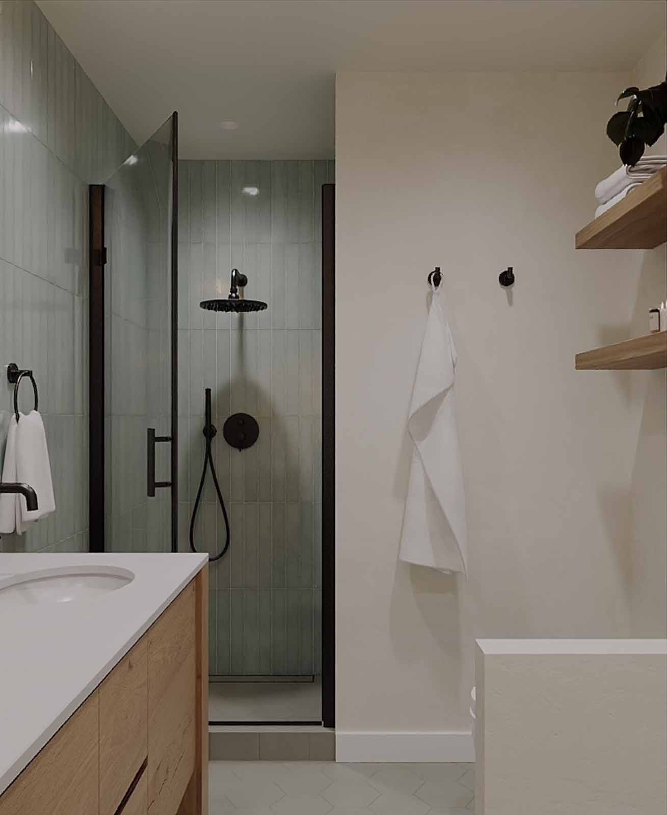 Walk-in shower design with sage vertical tile, rain showerhead, and floating wood shelves