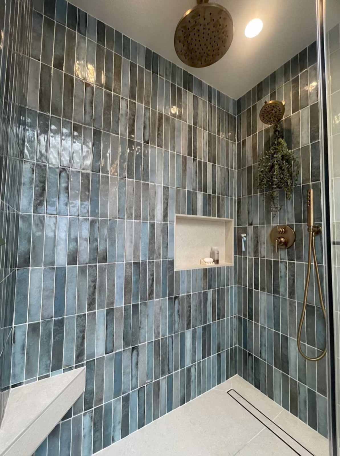 Floor-to-ceiling blue tile shower with brass fixtures and built-in niche in Glendale bathroom
