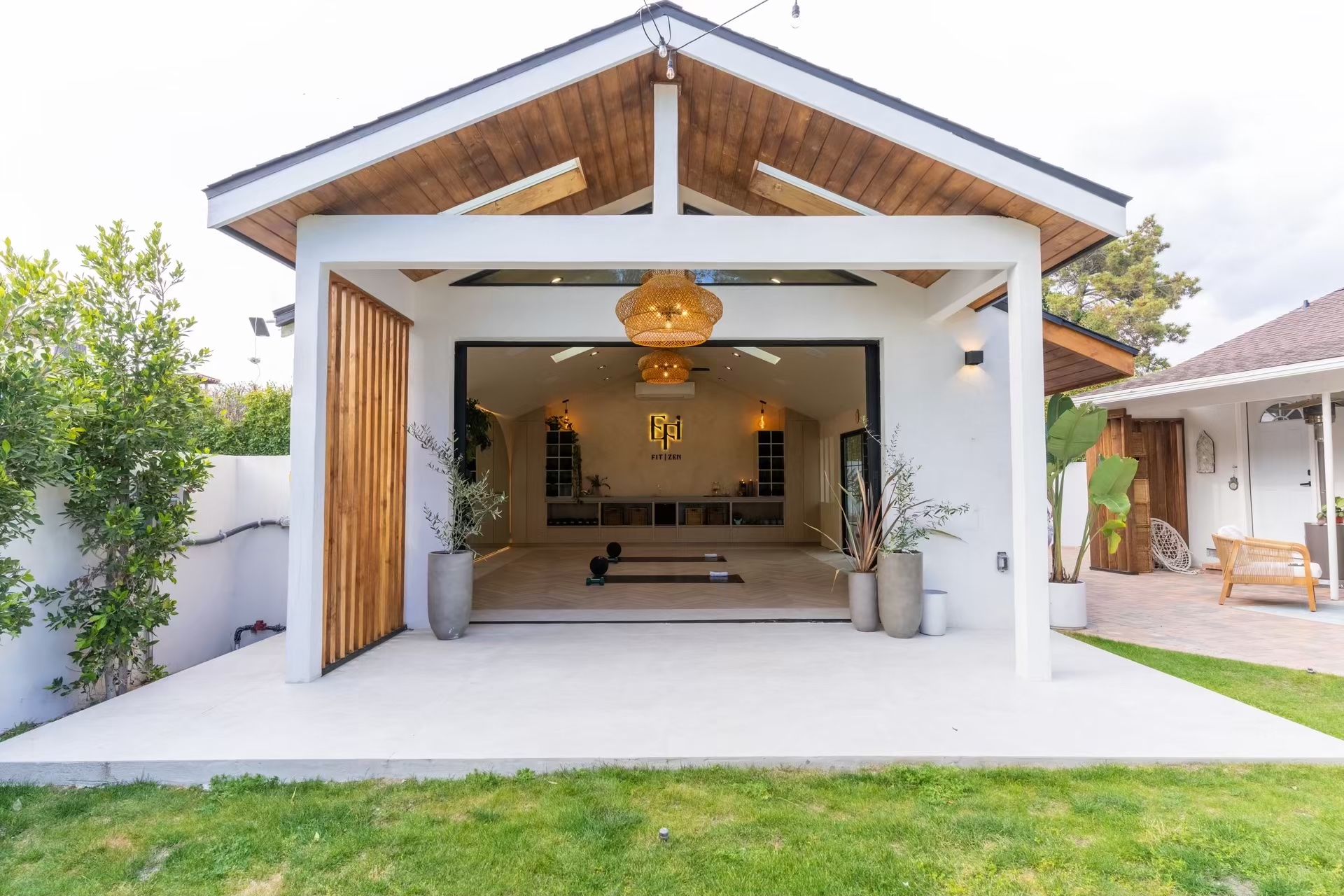 Modern ADU with exposed wood beam ceiling, open-air design, cedar slat details, and seamless indoor-outdoor flow - New Dawn Construction