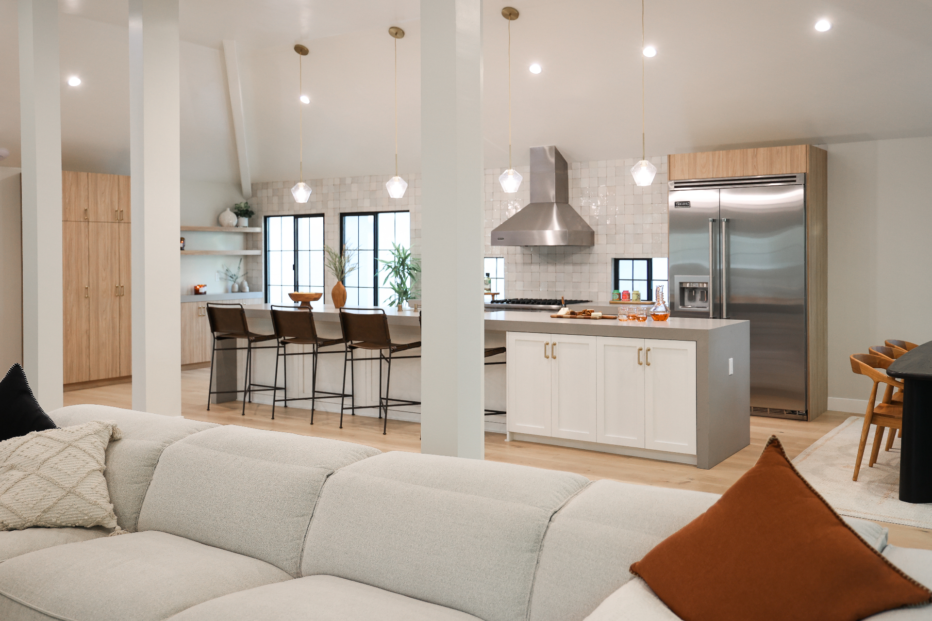 Modern open concept kitchen remodel with custom cabinets, quartz countertops, and stainless appliances