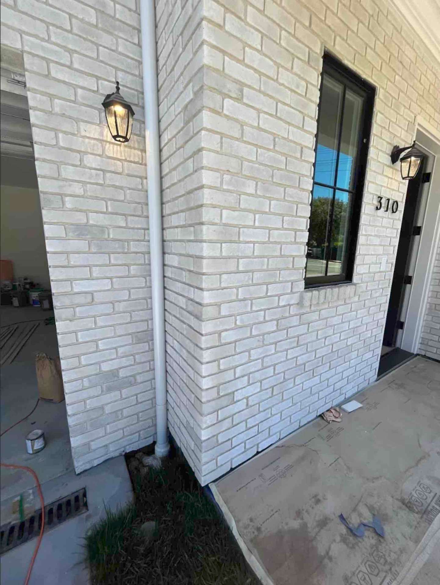 Pasadena room addition brick entry detail with lantern sconces and black-framed windows - quality masonry work