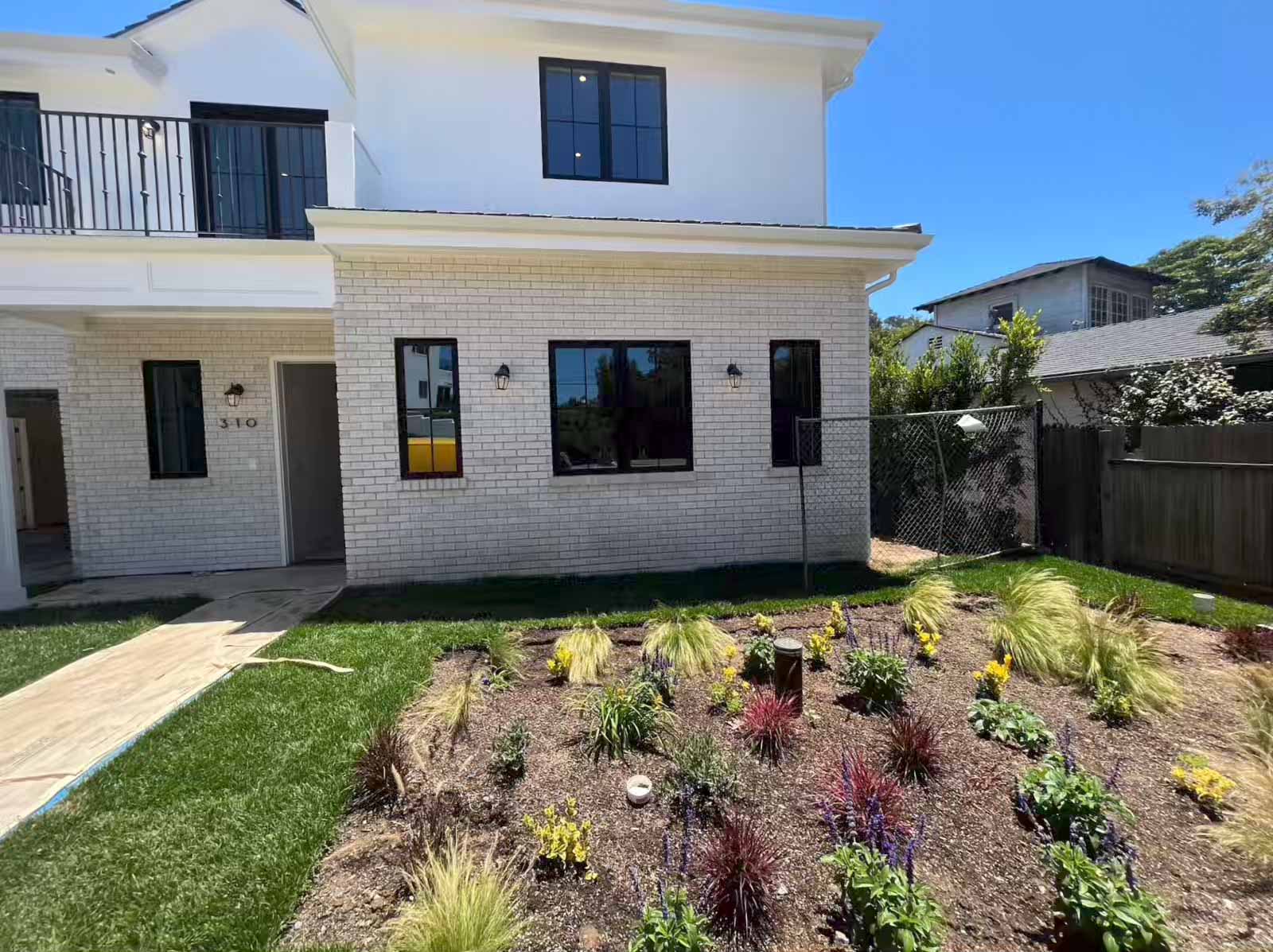Finished room addition Pasadena exterior with brick facade, new landscaping and curb appeal - home addition contractor