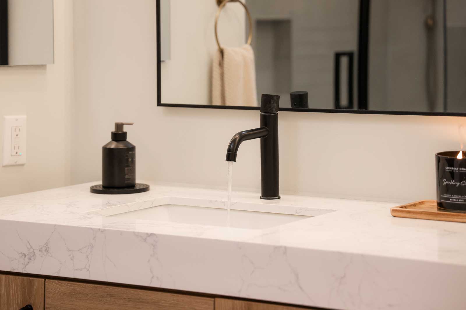 Modern matte black bathroom faucet on white marble-look countertop - premium bathroom fixtures LA