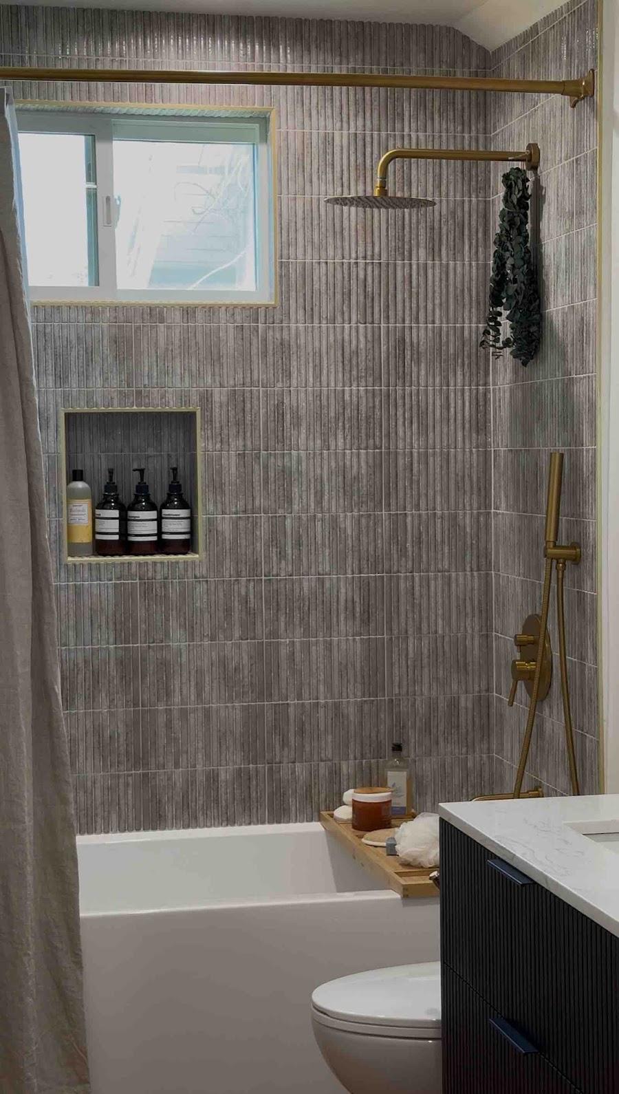 Agoura Hills bathroom with vertical green tile and skylight