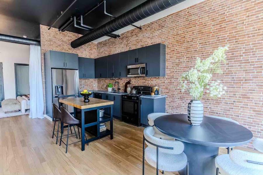 Hollywood Studio modern industrial living space with dramatic dark walls