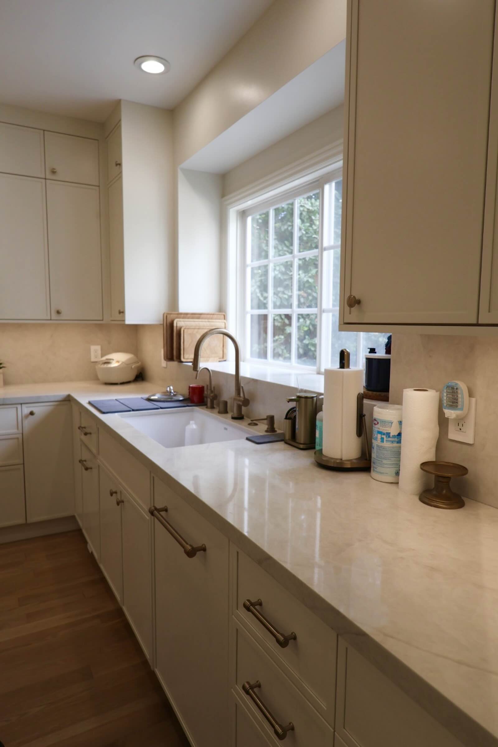 La Cañada Flintridge kitchen sink and marble-look counters under a garden window