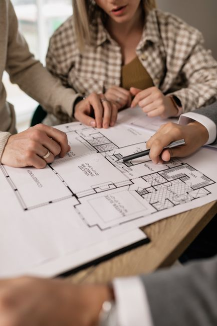 Homeowner and contractor reviewing plans and 
documents for a residential addition.